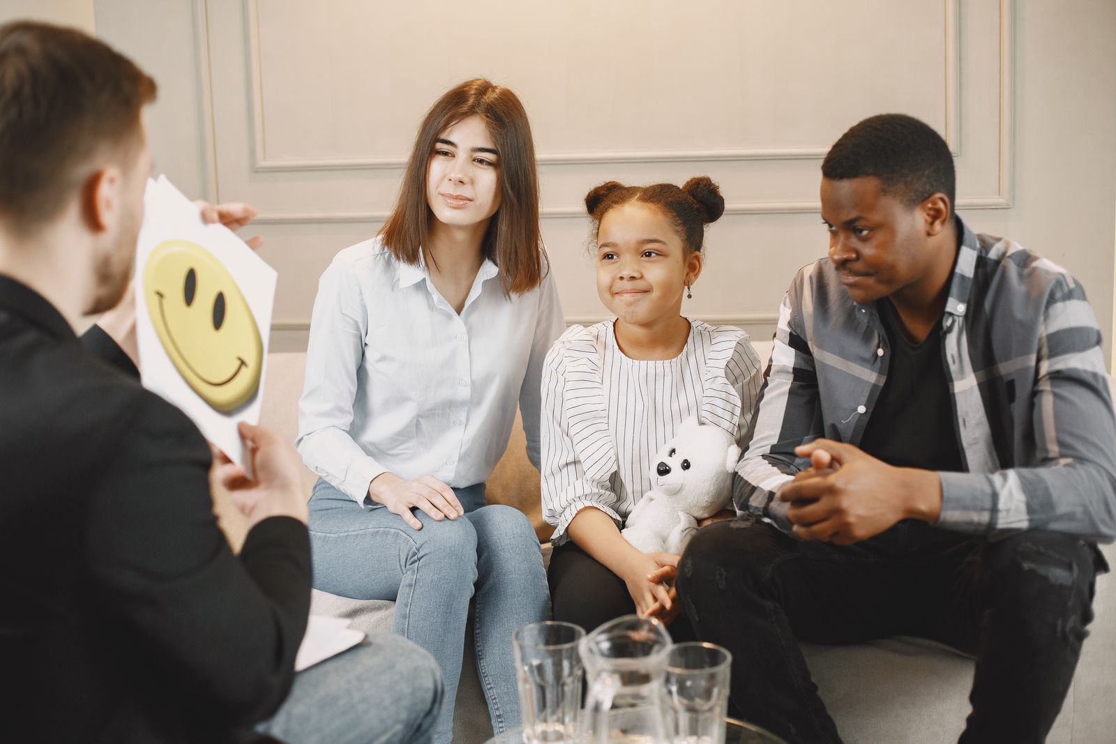 A family speaking with a therapist during a counseling session