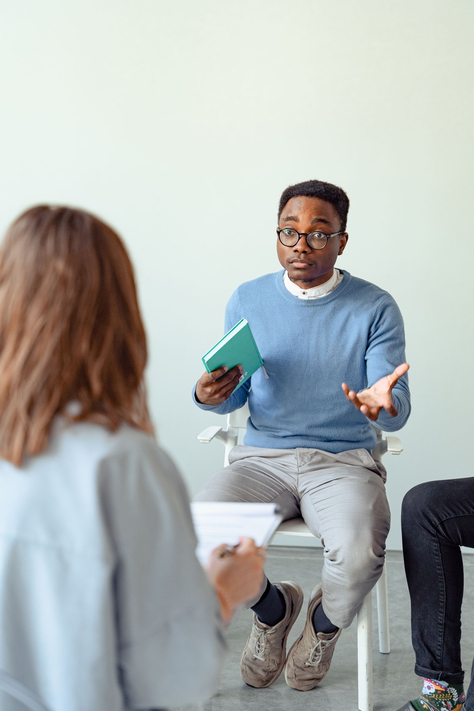 People gathered in a supportive group setting