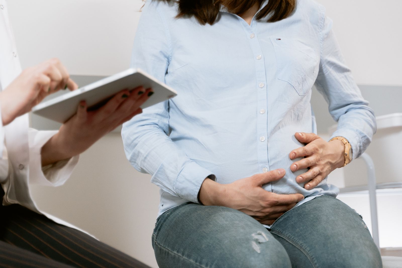 An expectant mother receiving professional support during a consultation