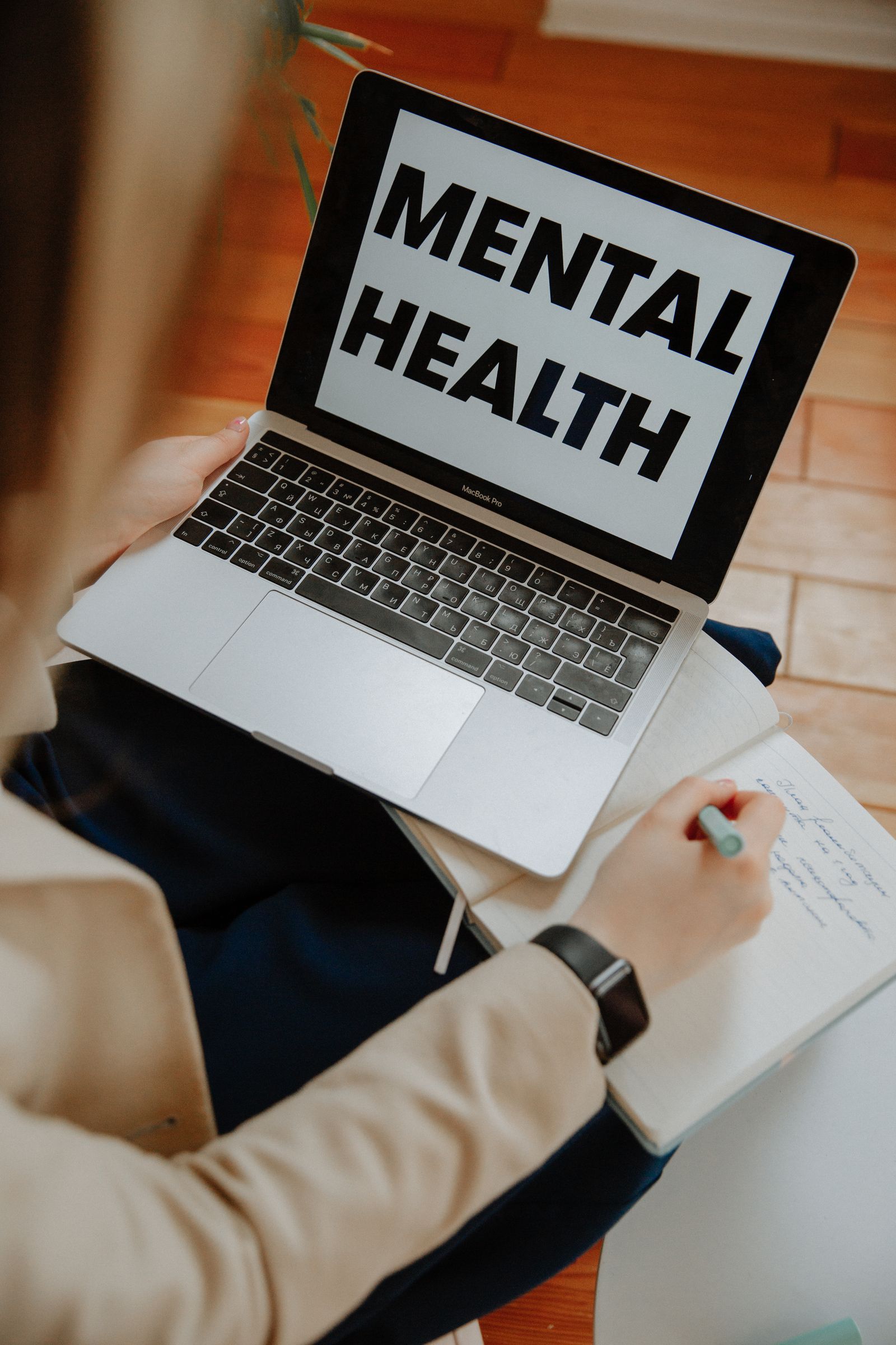 A client attending an online mental health session on a laptop